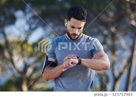Watch, monitor and man training for fitness, marathon motivation and cardio health in nature. Athlete runner check for time after run, exercise progress and reading notification after workout in park Watch, monitor and man training for fitness, marathon motivation and cardio health in nature. Athlete runner check for time after run, exercise progress and reading notification after workout in park 123757983