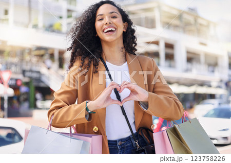 Heart, hands, shopping and woman with smile for retail, fashion and designer sale in the city of Miami. Portrait of a young girl in the street for a market, bags and love for store in the road 123758226