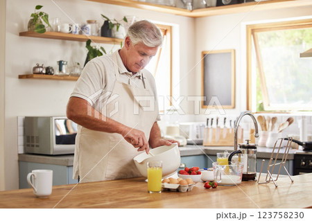 Senior man, cooking and baking in kitchen for wellness food, health breakfast and dessert cake. Retirement elderly, chef or baker in house or home with fruit, milk or eggs in recipe or bakery product 123758230