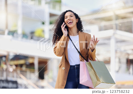 Happy woman, shopping and phone call in the mall in communication about lifestyle in the outdoors. Female shopper having conversation with smile and laugh on mobile smartphone in the city market Happy woman, shopping and phone call in the mall in communication about lifestyle in the outdoors. Female shopper having conversation with smile and laugh on mobile smartphone in the city market 123758232