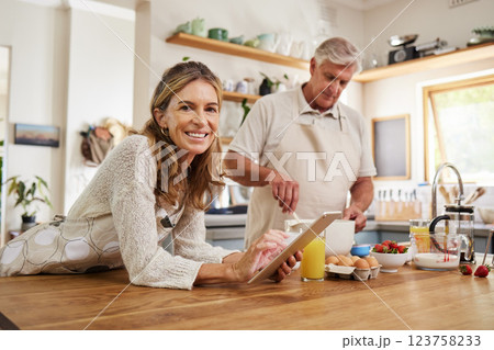 Cooking, tablet and senior couple reading information about food for breakfast on internet in the kitchen. Portrait of an elderly man and woman with digital video recipe on tech for lunch or dinner Cooking, tablet and senior couple reading information about food for breakfast on internet in the kitchen. Portrait of an elderly man and woman with digital video recipe on tech for lunch or dinner 123758233