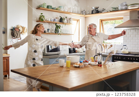 Senior couple, dance in kitchen and smile with love while making pancake breakfast in family home. Happy old man, dancing with smiling elderly woman and fun in retirement together while cooking food Senior couple, dance in kitchen and smile with love while making pancake breakfast in family home. Happy old man, dancing with smiling elderly woman and fun in retirement together while cooking food 123758328