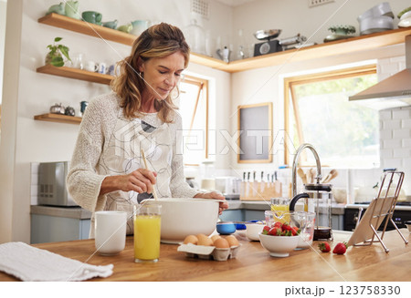 Kitchen, cooking and senior woman in kitchen with dessert, breakfast or healthy food for nutrition, wellness or retirement lifestyle. Elderly person, orange juice and baking pancakes in her kitchen Kitchen, cooking and senior woman in kitchen with dessert, breakfast or healthy food for nutrition, wellness or retirement lifestyle. Elderly person, orange juice and baking pancakes in her kitchen 123758330