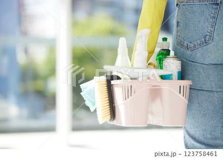 Person with basket of product for cleaning, in house or room working for hygiene company. Worker with brush, spray and chemical cleaner in hand, for spring cleaning home, kitchen or office building Person with basket of product for cleaning, in house or room working for hygiene company. Worker with brush, spray and chemical cleaner in hand, for spring cleaning home, kitchen or office building 123758461