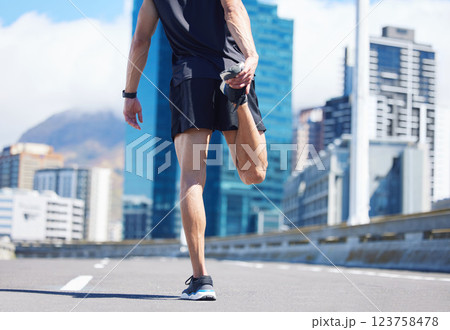 Man, stretching legs and back view in city, street or urban road outdoors. Fitness, health and male athlete stretch or warm up before exercise, running or training outside for marathon run in town. 123758478