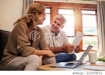 Laptop, senior couple and retirement planning with documents while sitting on sofa in the living room. Finance, budget and happy elderly man and woman working on pension fund, mortgage bills and debt Laptop, senior couple and retirement planning with documents while sitting on sofa in the living room. Finance, budget and happy elderly man and woman working on pension fund, mortgage bills and debt 123758511