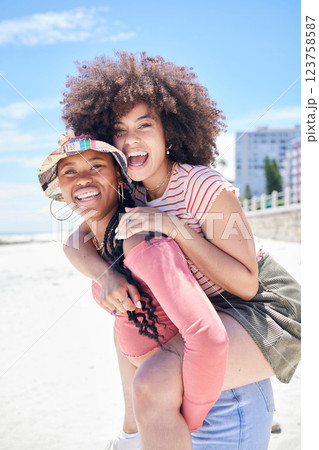 Friends, gay and lesbian with women happy on piggyback and fun at beach in summer. LGBTQ, dating and trust with happy female and her girlfriend on holiday, vacation or travel by the coast in summer 123758587