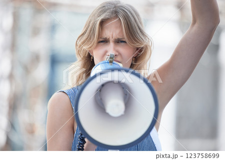 Protest, angry and woman talking with megaphone at a riot in the city of Iran. Face portrait of young girl making noise with an announcement on microphone while speaking about womens rights Protest, angry and woman talking with megaphone at a riot in the city of Iran. Face portrait of young girl making noise with an announcement on microphone while speaking about womens rights 123758699
