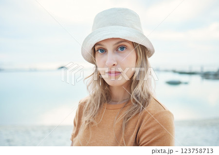Hipster woman, holiday at the beach and portrait of calm or relaxing Norway coastal getaway trip. Peaceful summer vacation, seaside sand and young person enjoying time alone at the Oslo ocean harbor 123758713
