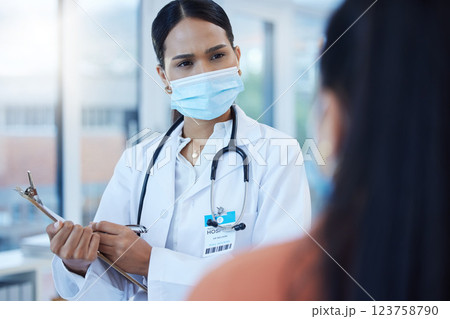 Covid mask, black woman doctor and medical patient at a hospital or clinic ask a health question. Insurance communication, medicine advice and cardiology consultation of a worker with help documents Covid mask, black woman doctor and medical patient at a hospital or clinic ask a health question. Insurance communication, medicine advice and cardiology consultation of a worker with help documents 123758790