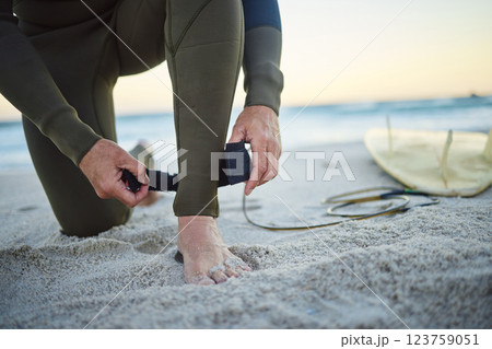 Foot, with surfboard and leash on sand prepare to enter sea, on beach and to relax on holiday, vacation and wet suit. Surfing, healthy man and ready to surf ocean for wellness and health on seaside. Foot, with surfboard and leash on sand prepare to enter sea, on beach and to relax on holiday, vacation and wet suit. Surfing, healthy man and ready to surf ocean for wellness and health on seaside. 123759051
