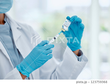 Doctor with covid vaccine, injection and corona virus medicine needle, bottle and syringe in hospital. Closeup nurse hands, healthcare and flu risk, viral vaccination and medical immunity treatment 123759368