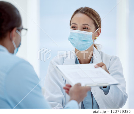 Doctor, woman and covid patient form for health consultation advice and records at hospital. Female healthcare nurse with mask offering document for vaccine agreement or pandemic safety regulations 123759386