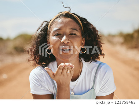 Happy woman, blowing kiss and portrait for love emoji, relax and flirting outdoors in Colombia. Young, smile and freedom gen z girl with expression of hand kisses, joy and summer happiness in nature Happy woman, blowing kiss and portrait for love emoji, relax and flirting outdoors in Colombia. Young, smile and freedom gen z girl with expression of hand kisses, joy and summer happiness in nature 123759465