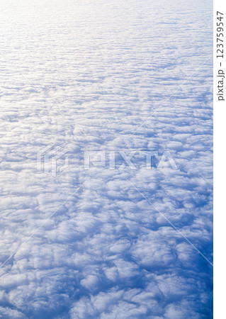 Aerial View of Soft, Beautifully Textured Clouds Hovering in the Clear Blue Sky Above, Background white clouds top view 123759547