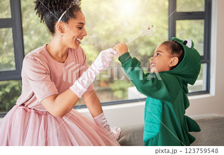 Child halloween party, mother as princess and girl in dinosaur suit for for creative kid development in home together with lens flare. Happy mom with kid birthday in a fantasy or fairy character 123759548
