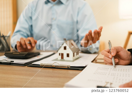 Businesswoman embraces client after successful property negotiation. Businesswoman embraces client after successful property negotiation. 123760052