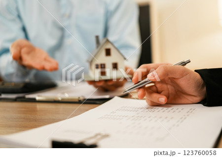 Businesswoman embraces client after successful property negotiation. 123760058