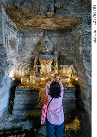 People put gold leaf on to the Buddha statue and pray respect to The Statue of buddha 123760793