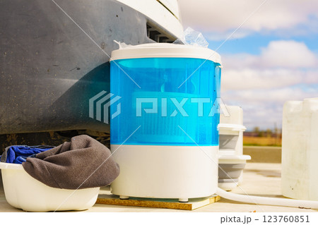 Washing laundry outdoor at caravan 123760851
