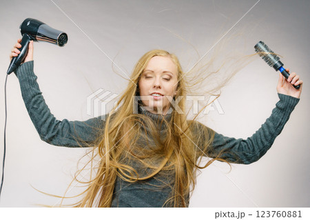 Girl holds hair accessories, styling hair 123760881