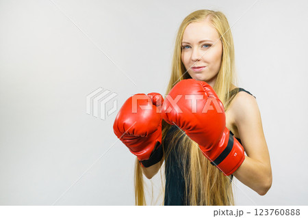 Woman in gloves playing sports boxing Woman in gloves playing sports boxing 123760888