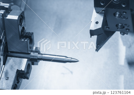 The  CNC lathe machine forming cutting the metal shaft parts in the light blue scene. 123761104