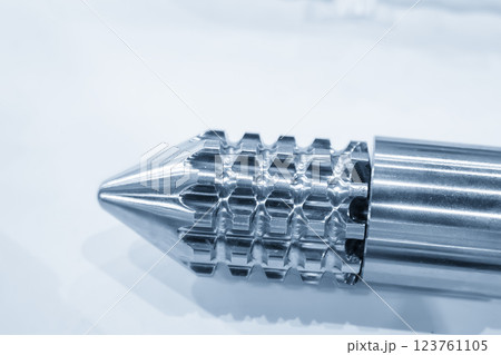 Close up scene the head of barrel screw of injection machine spare parts in the light blue scene. 123761105