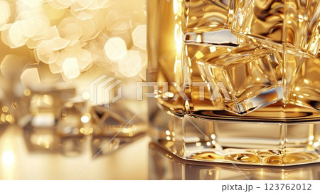 Close-Up of Whiskey Glass with Ice and Golden Bokeh 123762012