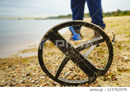 Man with metal detector on sea beach Man with metal detector on sea beach 123762070