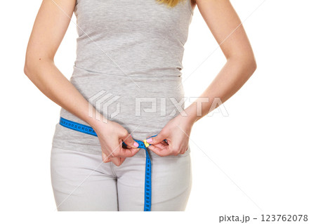 Woman measuring her hips closeup Woman measuring her hips closeup 123762078