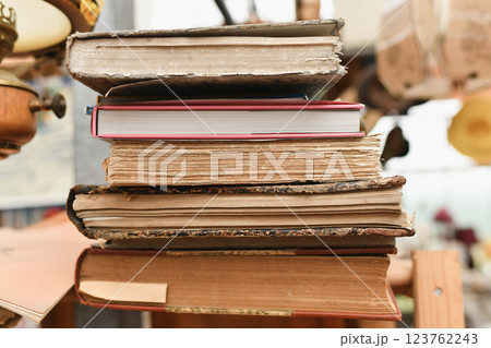 Stack of worn tattered antique books in a vintage shop 123762243