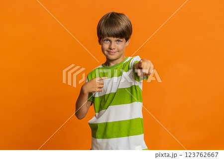 Smiling happy boy pointing forward to camera choosing lucky victory winner indicating promotion 123762667
