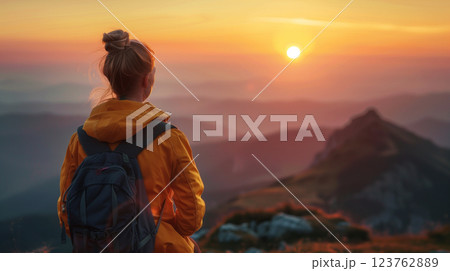 woman meditating on the mountains on the sunrise 123762889