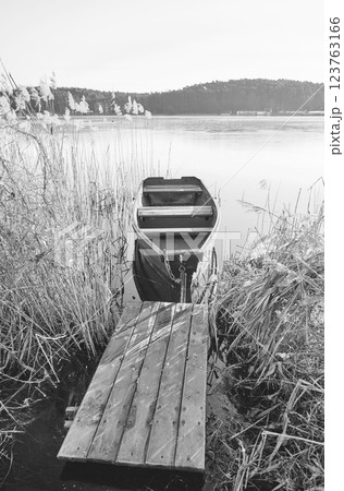 A small fishing boat on the shore of a lake, Barlinek, Poland. A small fishing boat on the shore of a lake, Barlinek, Poland. 123763166