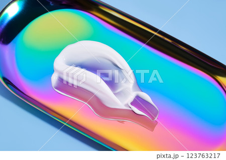 The texture of white cream on a multicolored background. 123763217