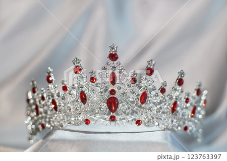 Royal crown with red gemstones, garnets 123763397