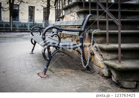 Park Bench Secured with Chain and Lock in Urban Outdoor Area Park Bench Secured with Chain and Lock in Urban Outdoor Area 123763425