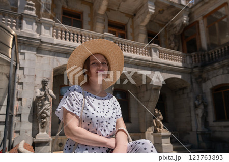 A woman wearing a straw hat 123763893
