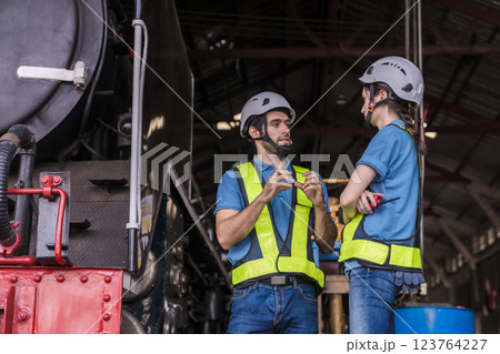 Engineer checking construction process railway and checking work on railroad station . Engineer checking construction process railway and checking work on railroad station . 123764227