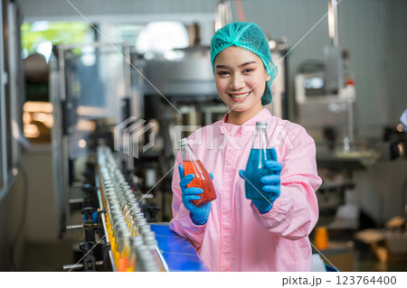 Worker Checking quality or checking stock of glass bottle in beverage factory Worker Checking quality or checking stock of glass bottle in beverage factory 123764400