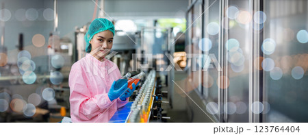 Worker Checking quality or checking stock of glass bottle in beverage factory 123764404