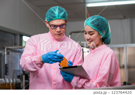 Worker Checking quality or checking stock of glass bottle in beverage factory Worker Checking quality or checking stock of glass bottle in beverage factory 123764420