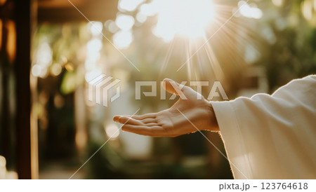 Hand of Jesus reaching out with light in spiritual scene, copy space background Hand of Jesus reaching out with light in spiritual scene, copy space background 123764618
