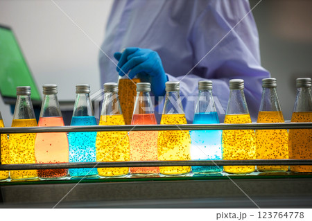 Worker Checking quality or checking stock of glass bottle in beverage factory Worker Checking quality or checking stock of glass bottle in beverage factory 123764778