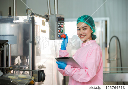 Worker Checking quality or checking stock of glass bottle in beverage factory. Worker Checking quality or checking stock of glass bottle in beverage factory. 123764818