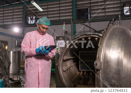 Worker Checking quality or checking stock of glass bottle in beverage factory.  123764831