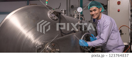 Worker Checking quality or checking stock of glass bottle in beverage factory.  123764837