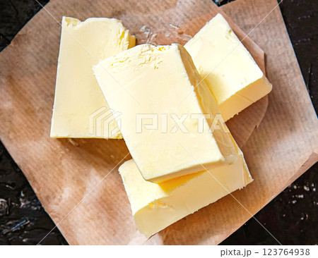 Fresh farm butter on parchment. Homemade butter Fresh farm butter on parchment. Homemade butter 123764938