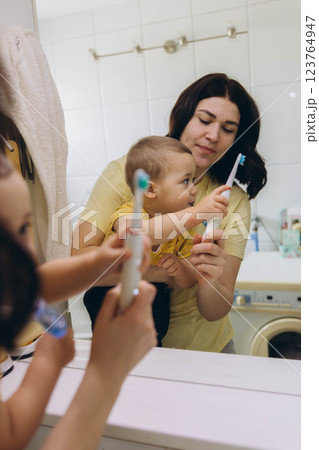 Dental care, mother brushing teeth with boy for wellness,Bathroom, oral health toothbrush 123764947